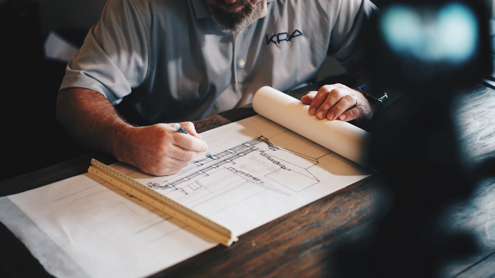 Architect reviewing residential drawings on a workbench