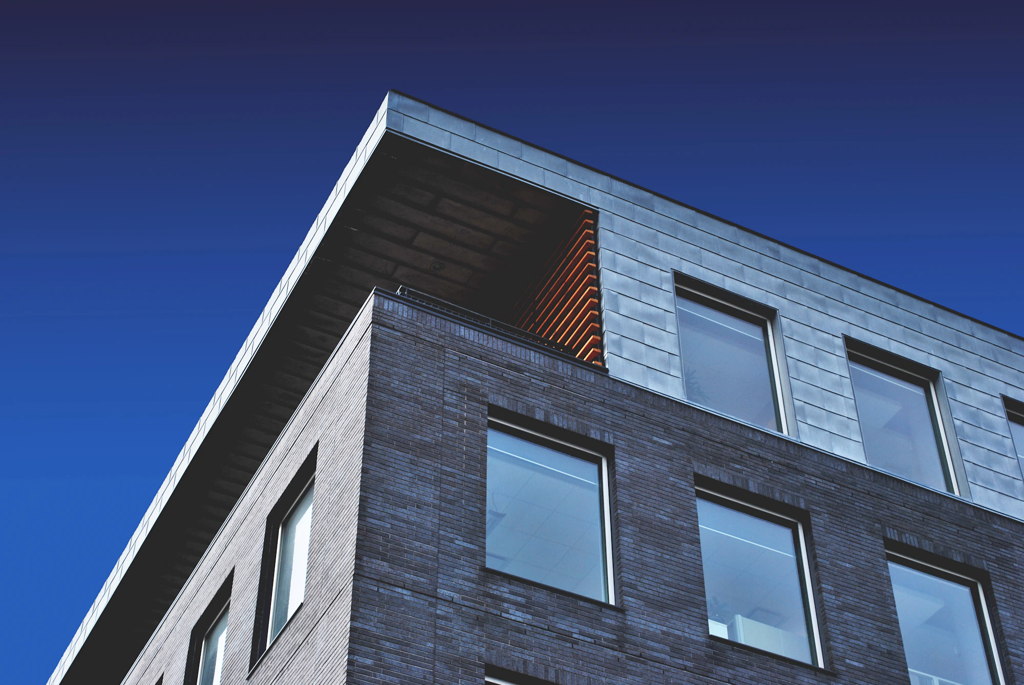 Modern multi-residential corner against dusk sky
