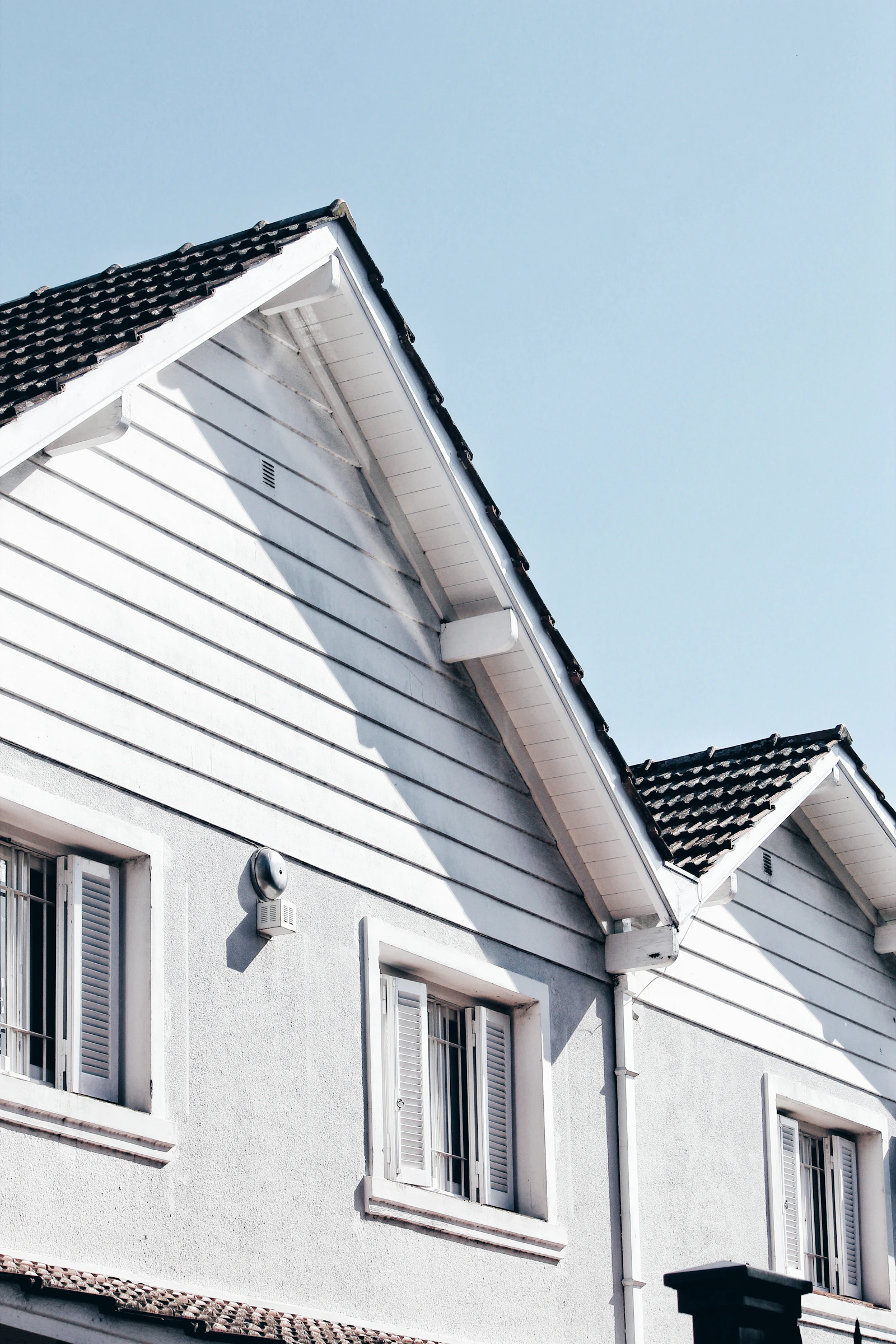 Residential gable roof under clear sky